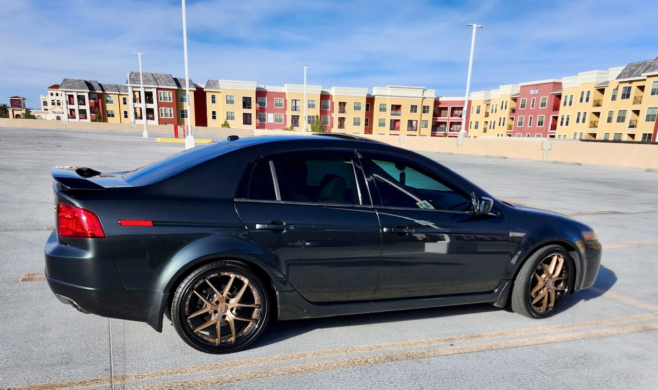 Dark gray Acura TL sedan with bronze wheels, lowered